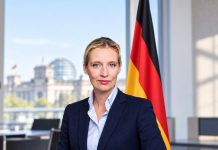 Weidel ostrzega przed scenami jak z wojny domowej w Niemczech! Wskazuje na masową migrację i lewicowy ekstremizm Ilustracja Alice Weidel w biurze z flagą Niemiec