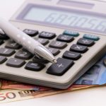 Euro banknotes and calculator