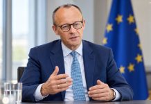 Merz ostrzega Niemców przed Rosją! Wielu nie traktuje zagrożenia poważnie Friedrich Merz podczas symbolicznej rozmowy — ilustracja AI