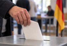 Polityk SPD chce rozmów z AfD! „Nie wolno jej teraz ignorować i wykluczać” Ilustracja AI: wrzucanie karty do urny wyborczej, w tle flaga Niemiec